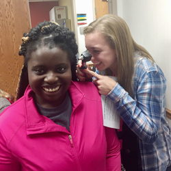 Charleston High School student Kressa Sweeney uses an otoscope to examine homeschooled student Anagrace Karrick at the October 2016 Health CareeRx Club event at the Sarah Bush Lincoln Neoga Clinic.