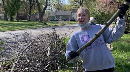 Medical Student Raking Leaves at Student Day of Service