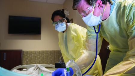 Doctors by patients bedside