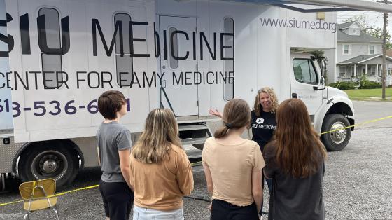 Photo of community members taking a tour of mobile care-a-van