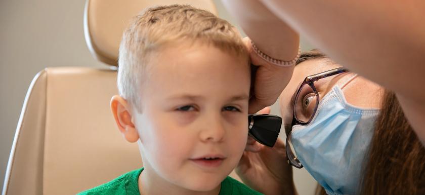 Doctor looking in patients ear photo