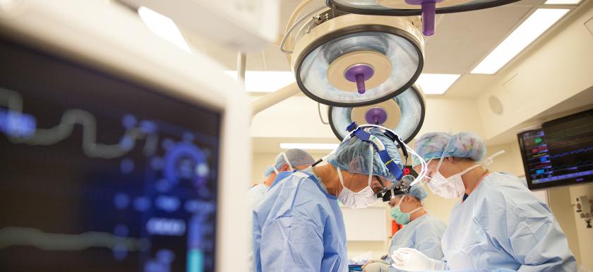 Doctors in personal protective gear ready to perform surgery