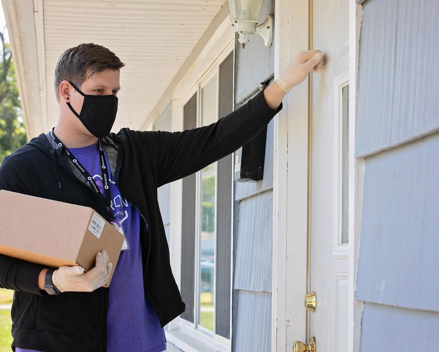 Community Health Worker Knocking on Door