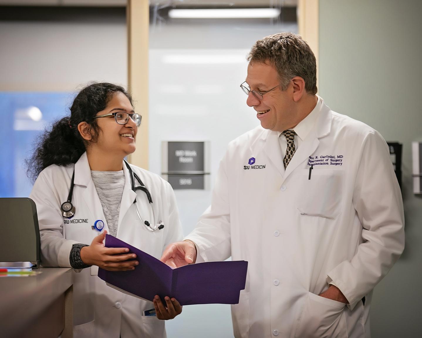 Doctor with Medical Student in Clinic