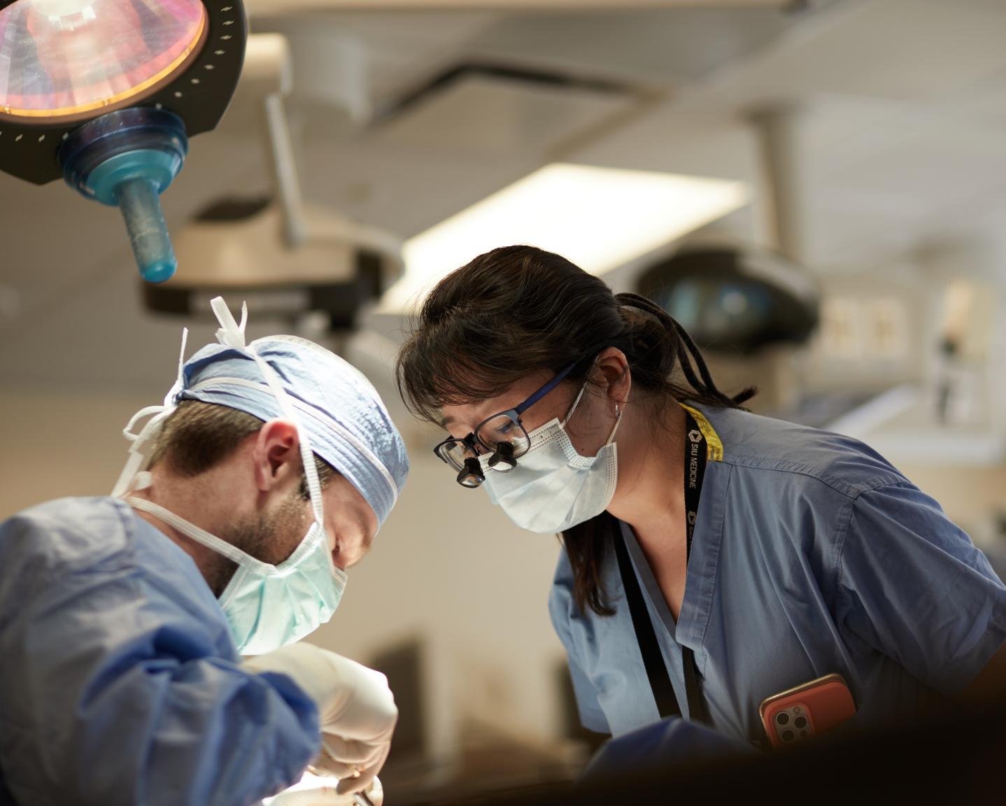 Dr. Zhang supervises residents in the Surgical Skills Lab
