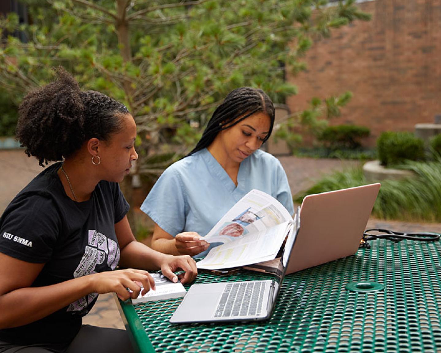 Medical students study in the courtyard of SIU School of Medicine