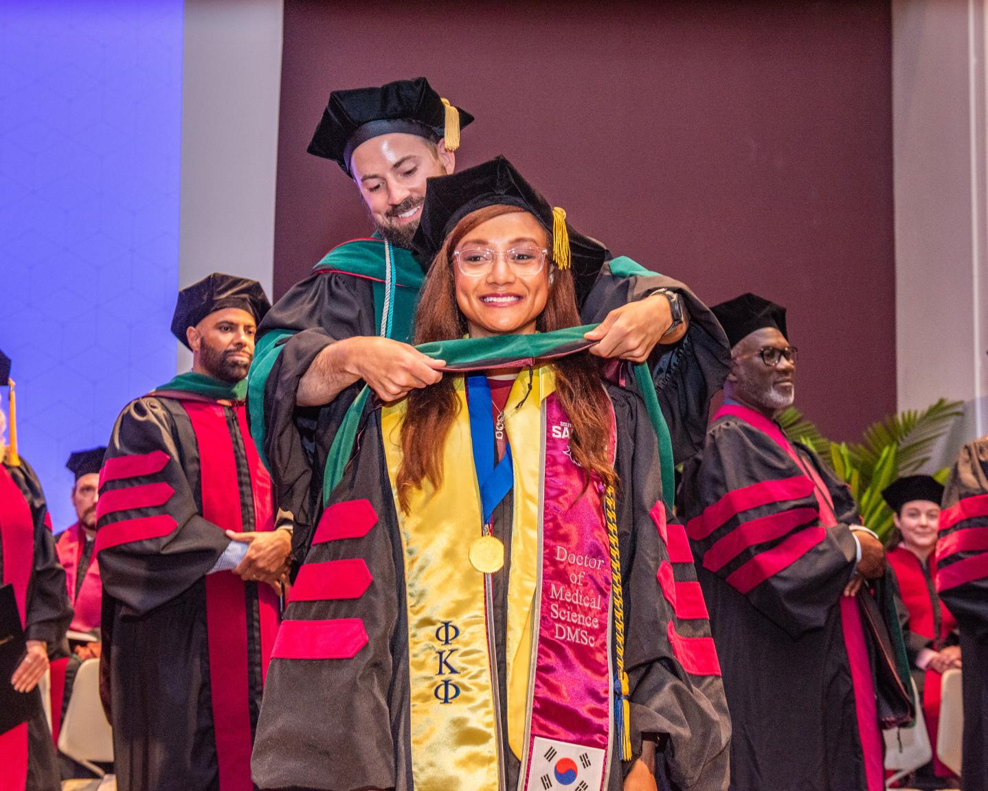 Image of a class Jang Mi (Bernice) Johnson being hooding at the 2025 DMSc Hooding Ceremony