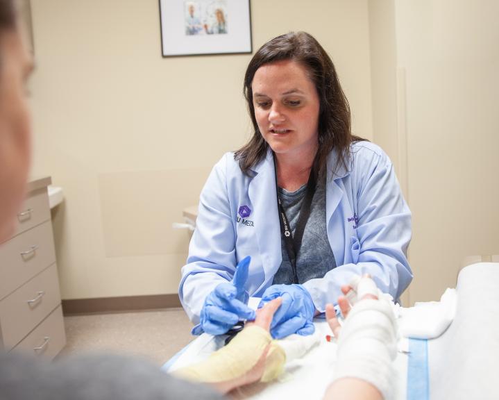 NP treating burn patient