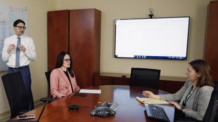 Office of Population Science & Policy Discussing at a Table