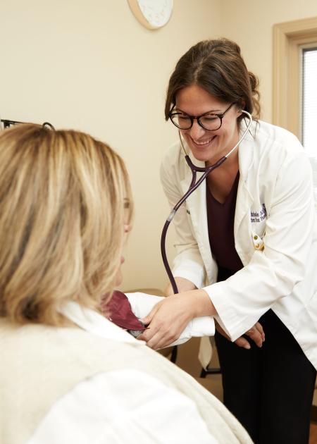 Physician assistant measures blood pressure