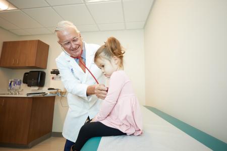 Photo of Dr. Carlson with pediatric patient