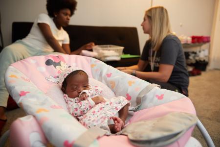 Photo of nurse working with family 