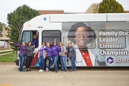 SIU Employees in front of bus with SIU Med logos