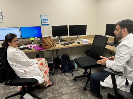 Internal Medicine resident talks to attending physician