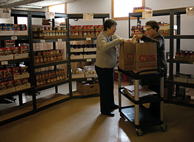 Shelly Weatherholt picks up groceries at the food pantry to stock a new resident’s home.